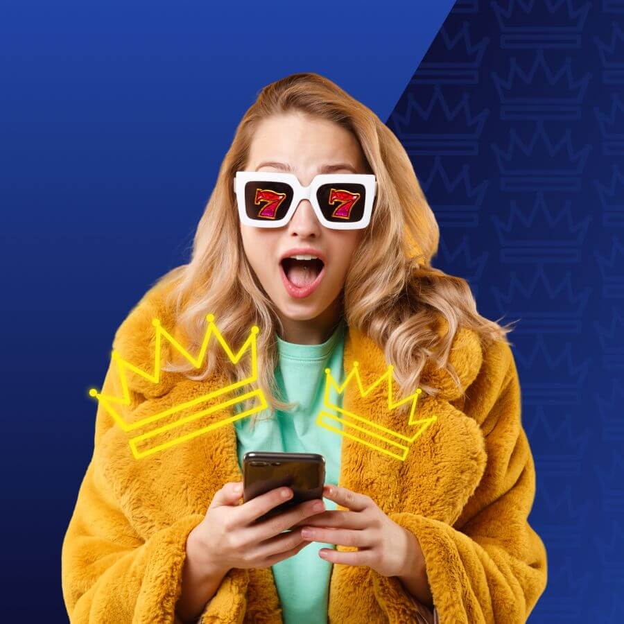 Surprised young woman in a yellow faux‑fur coat holds a smartphone, wearing white novelty sunglasses with red sevens and neon yellow crown drawings overlaying her torso.