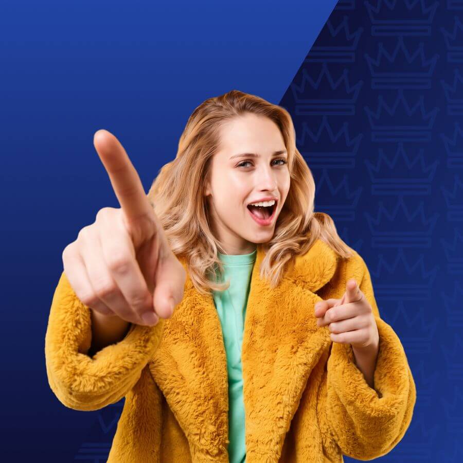 Smiling woman in a yellow faux‑fur coat points at the viewer against a blue gradient background.